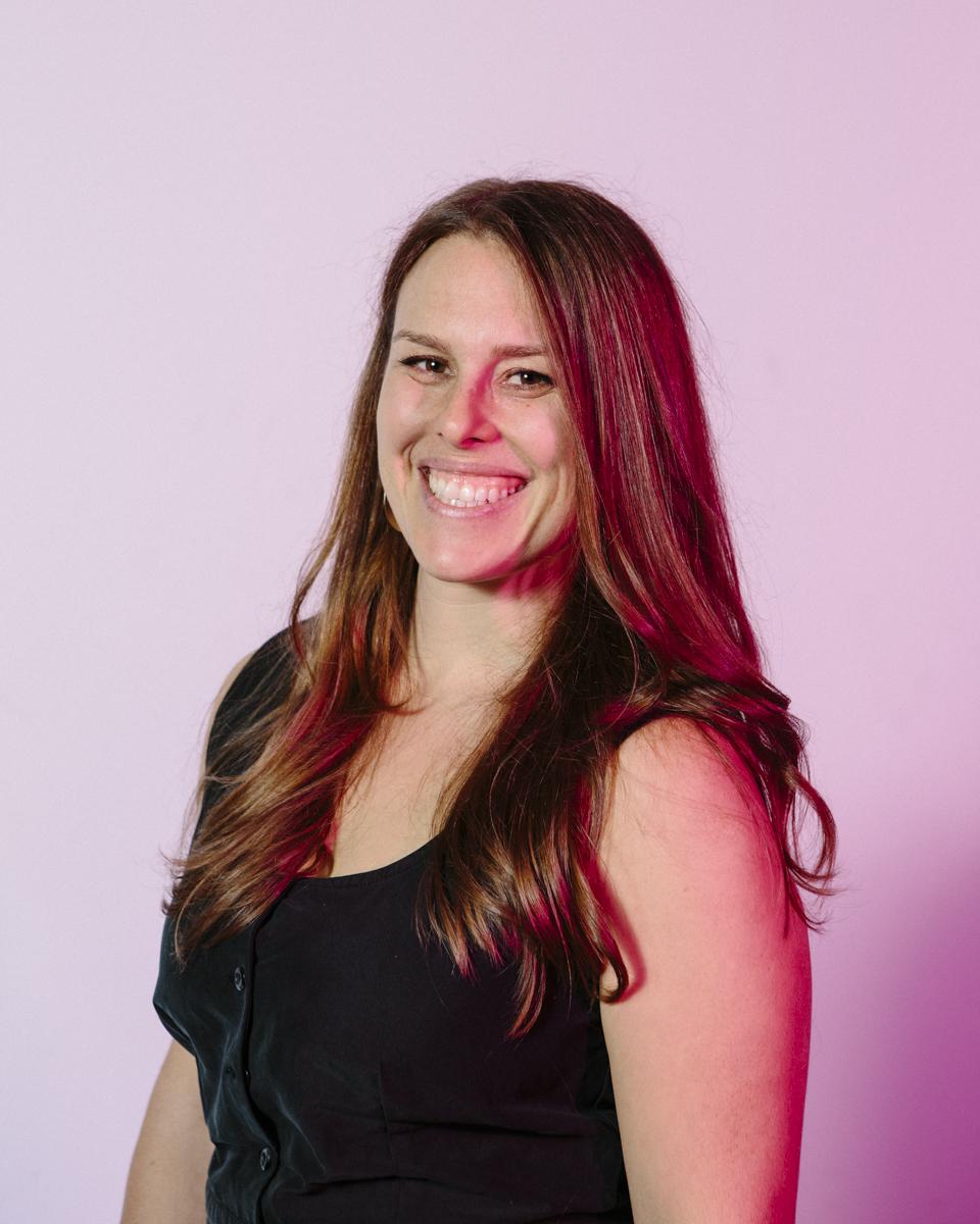 Headshot of Lisa Riordan Seville, a woman with medium length hair, smiling and looking at the camera.